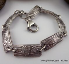 a silver bracelet with an ornate design on it