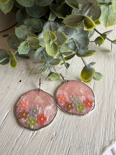 Resin earrings set in a silver colored metal bezel. Hang about 2 1/2". Light shimmery pink background. Perfect for the spring and summer. Nickel Free Flower Earrings For Summer, Silver Adjustable Flower Earrings For Summer, Silver Earrings For Spring Party, Silver Earrings For Party In Spring, Silver Party Earrings For Spring, Spring Party Silver Earrings, Pink Metal Drop Flower Earrings, Silver Flower Metal Earrings For Spring, Spring Silver Metal Flower Earrings