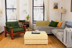 a living room with two couches, a chair and a coffee table in it