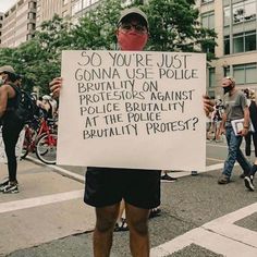 a protester holds up a sign that reads so you're just gonna use police