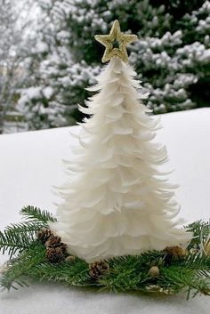 a christmas tree made out of paper and pine cones is shown in four different pictures