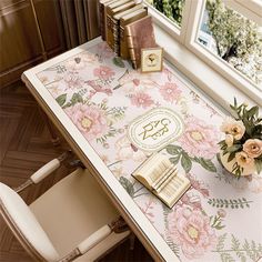 a desk with flowers and books on it