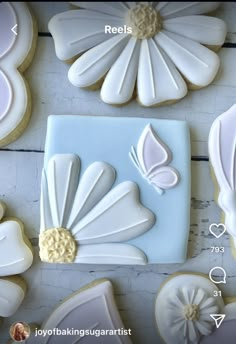 some cookies are decorated with white icing and flower decorations on them, along with other cookie decorating supplies