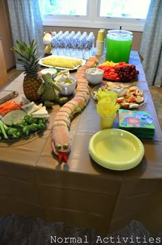 a table filled with food and drinks on top of a carpeted floor next to a window