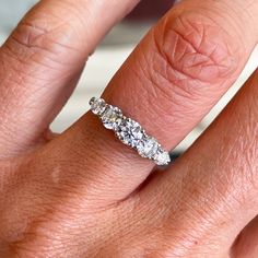 a woman's hand with a diamond ring on it