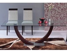 a glass table with two chairs and a rug on the floor in front of it