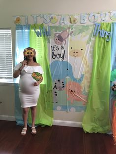 a pregnant woman is standing in front of a door with her hands on her face