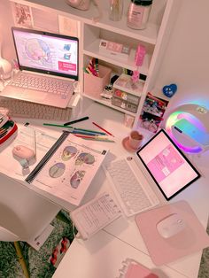 a laptop computer sitting on top of a white desk