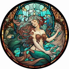 a stained glass window with a mermaid sitting on it's stomach and holding a fish