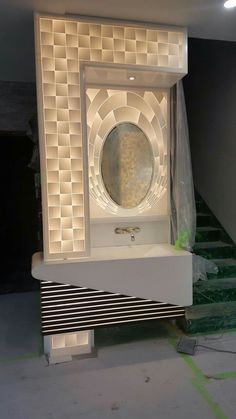 a white sink sitting on top of a counter next to a stair case in a room