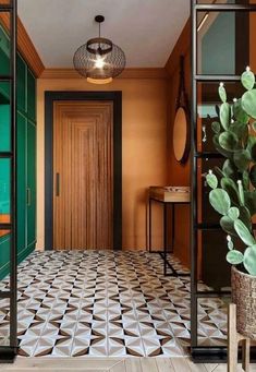 a hallway with tiled floors and green doors