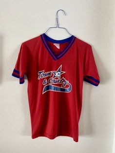 "Vintage 90's T&C Jersey, #4 BARRON Good condition, normal wear to be expected for the age of the item. Thick sweatbands on V-neck collar and short sleeves, Reminiscent of the 70's. Super soft and well loved. A few tears on left shoulder, as shown in pics. Graphic is still vibrant, as well as the name and number across back. Fun vintage piece! Measurements lying flat: pit to pit: 18.5\" shoulders: approx 17\" top of shoulder to bottom hem (length): 27\" sleeve: 13\"" Affordable Vintage T-shirts For Sports Season, Cheap 90s Sports T-shirt, Retro Red Top With Letter Print, 90s Style Red T-shirt For Sports, Retro Crew Neck Tops For Sports Season, Sporty Red Tops For Baseball Season, Retro Tops For Sports Events In Summer, Red Throwback Tops For Game Day, Retro Tops For Summer Sports Events