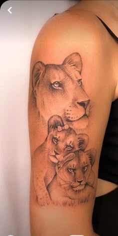 a woman's arm with two lions on it and the other one behind her