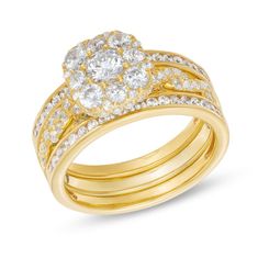 two tone gold wedding ring set with round diamonds on each band and an oval diamond center