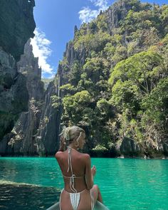 a woman sitting on top of a boat in the water