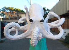 an octopus sculpture is shown in front of a building