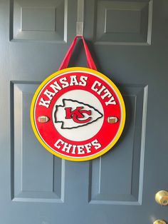 a kansas city chiefs sign hanging on a door