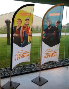 two flags with images of people on them in front of a window that says flyer de fliers