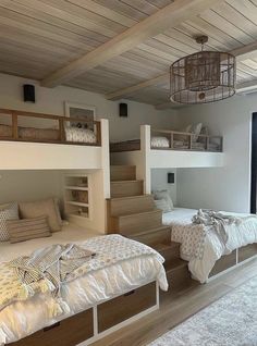 a bedroom with bunk beds and stairs in it