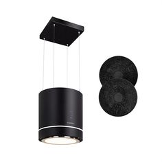 a black and white light hanging from the ceiling next to an object that looks like a speaker