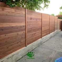 a wooden fence is shown next to a sidewalk