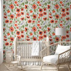 a baby's room with an orange flower wallpaper and rocking chair in front of the crib