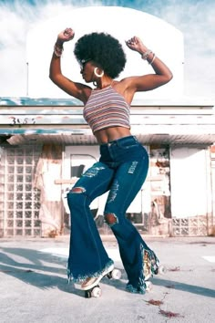 a woman in ripped jeans doing a trick on a skateboard