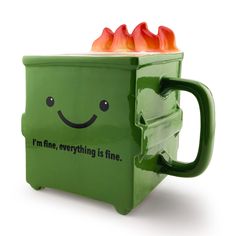 a green mug with flames sticking out of it's sides that says i'm fine, everything is fine