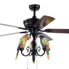 a ceiling fan with stained glass parrots on it's blades and two lights