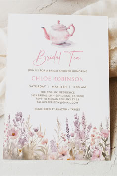 the bridal tea party is set up with pink flowers and a white teapot