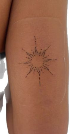 a woman's thigh with a small tattoo on the back of her leg,