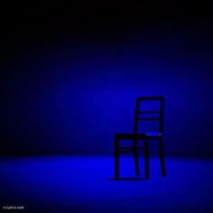 a chair sitting in the middle of a room with blue light on it's sides