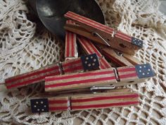 several wooden dominos are stacked on top of each other next to a metal spoon