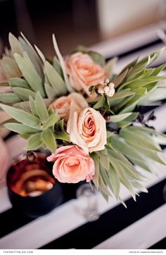 a vase filled with flowers sitting on top of a table