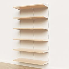 an empty shelf in the corner of a room