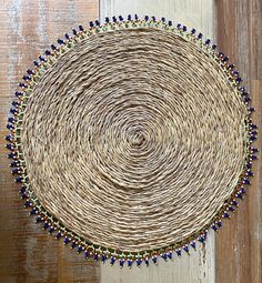 a woven placemat with beads on it