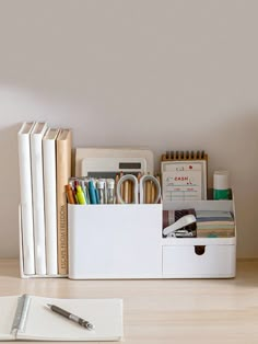 an office desk with books, pens and pencils