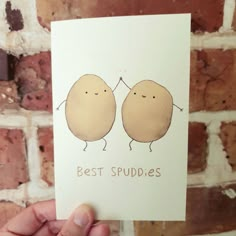 a hand holding up a card with two little potatoes on it that says best buddies