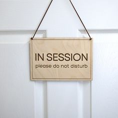 a sign hanging on the door saying in session please do not disturb