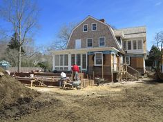 two men are working on the construction of a house