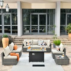 an outdoor living area with couches and tables