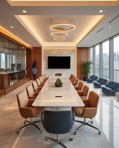 a conference room with chairs and a large table in front of a flat screen tv