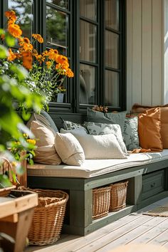 a wooden bench sitting on top of a wooden floor next to a window filled with flowers