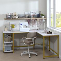 a sewing machine sitting on top of a desk next to a window