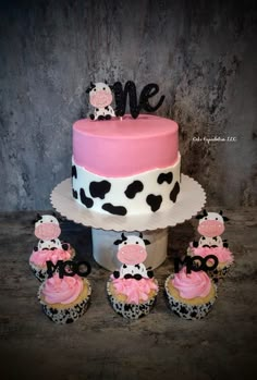 a cake and cupcakes are sitting on a table