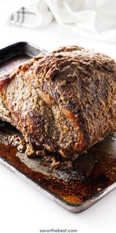 a meatloaf sitting on top of a pan covered in sauce