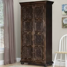 an old wooden armoire in a living room