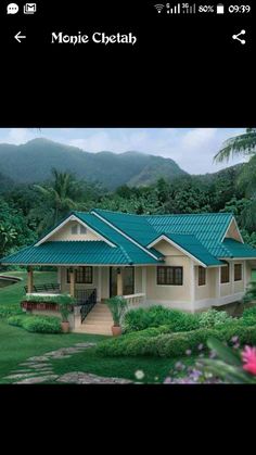 an image of a house in the middle of some bushes and trees with mountains in the background