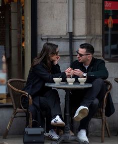 a man and woman sitting at a table talking