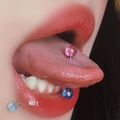 a close up of a person's nose with fake piercings on her tongue